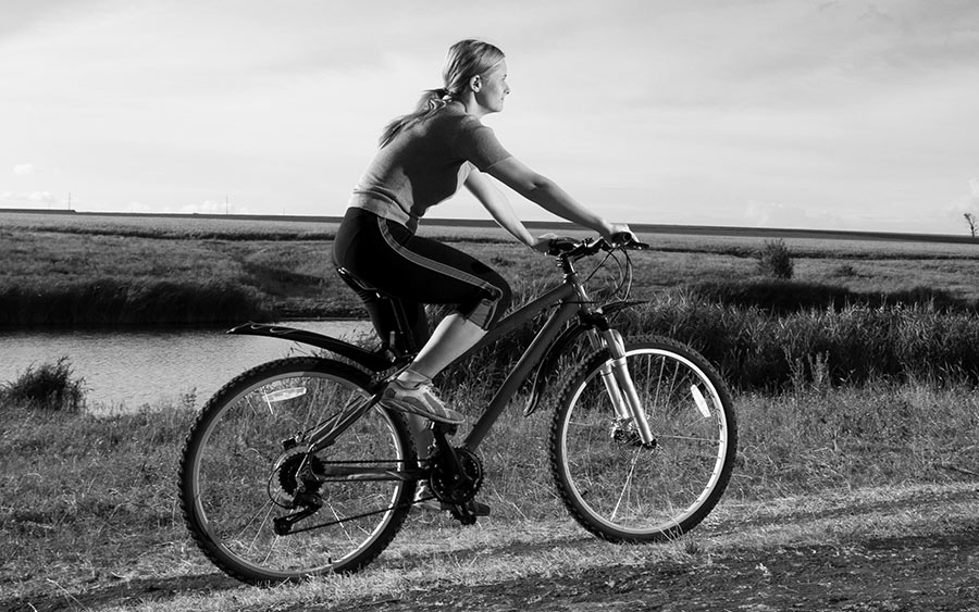 A woman riding a bike outdoors