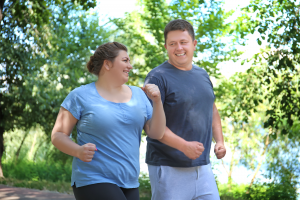 A man and woman outside going for a run